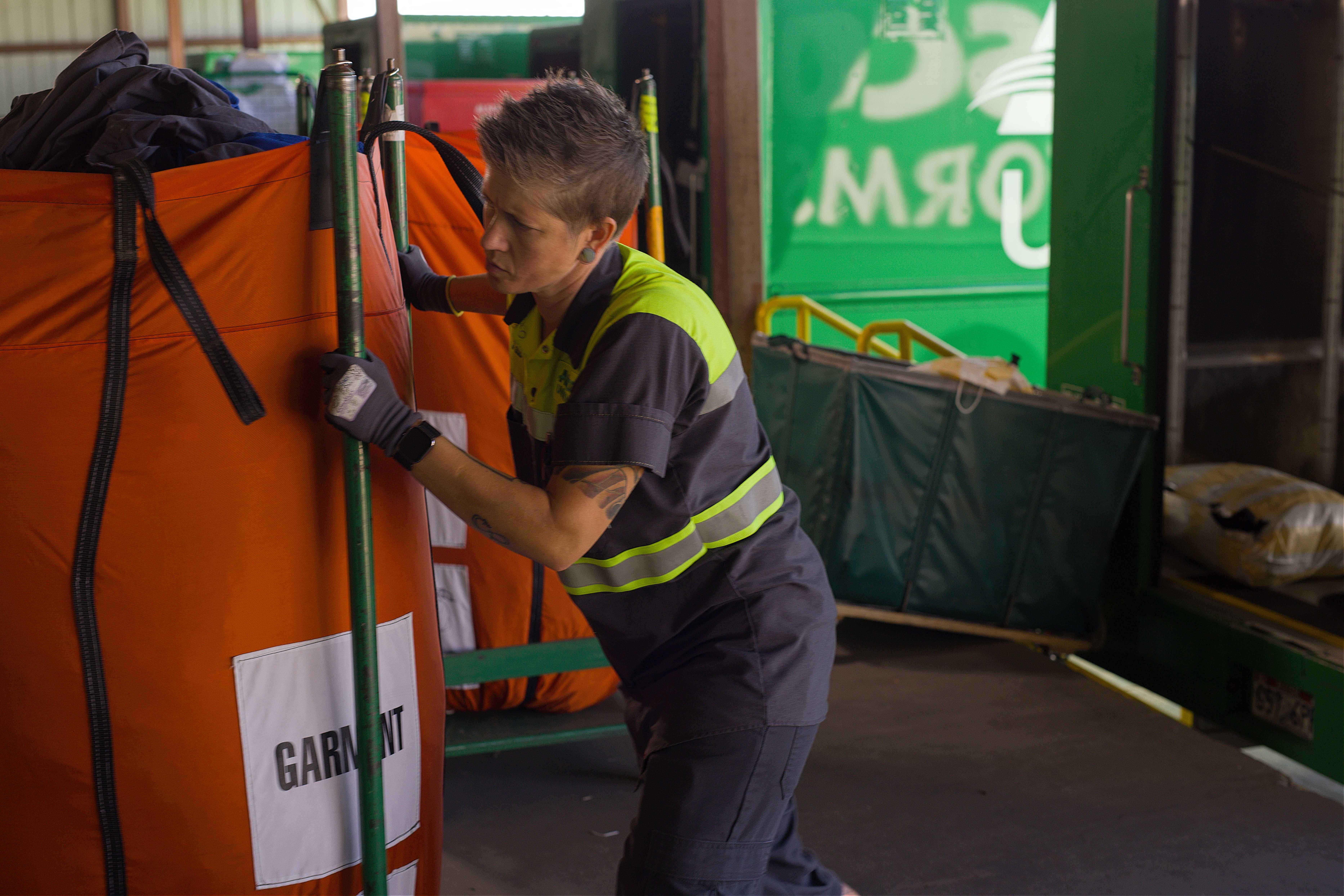 Alsco employee moving garments